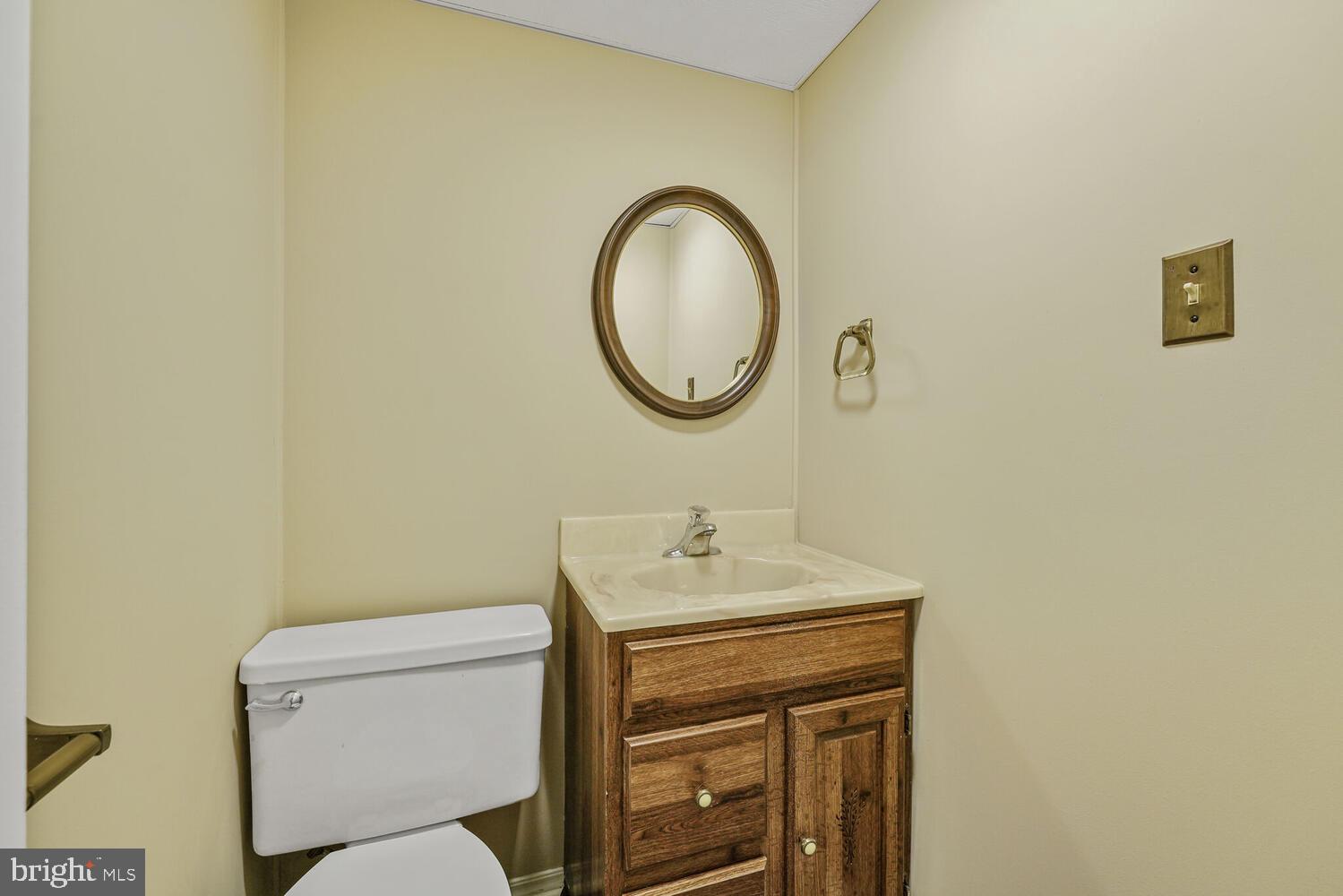 5932 Queenston Street Springfield, VA 22152 - Photo 31 of 47 a bathroom with a toilet sink and mirror