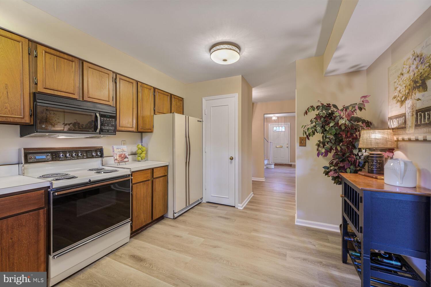 5932 Queenston Street Springfield, VA 22152 - Photo 8 of 47 a kitchen with stainless steel appliances granite countertop a stove a sink dishwasher a refrigerator and a microwave
