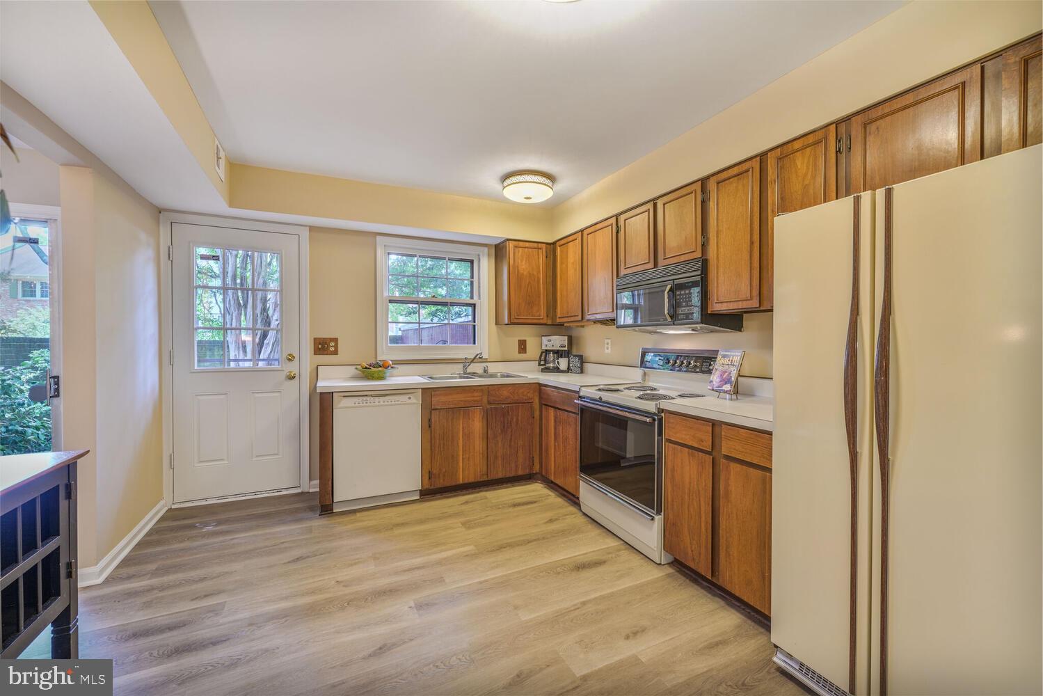5932 Queenston Street Springfield, VA 22152 - Photo 9 of 47 a kitchen with a refrigerator a sink and a stove top oven