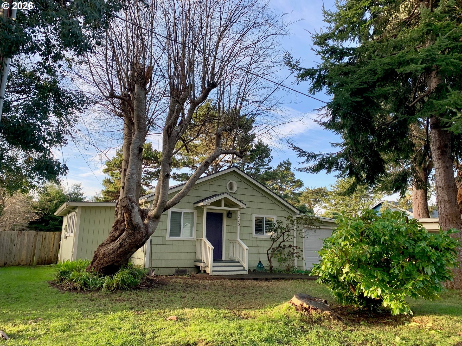 770 9th Street Southeast Bandon, OR 97411 - Photo 1 of 47 a front view of a house with a yard