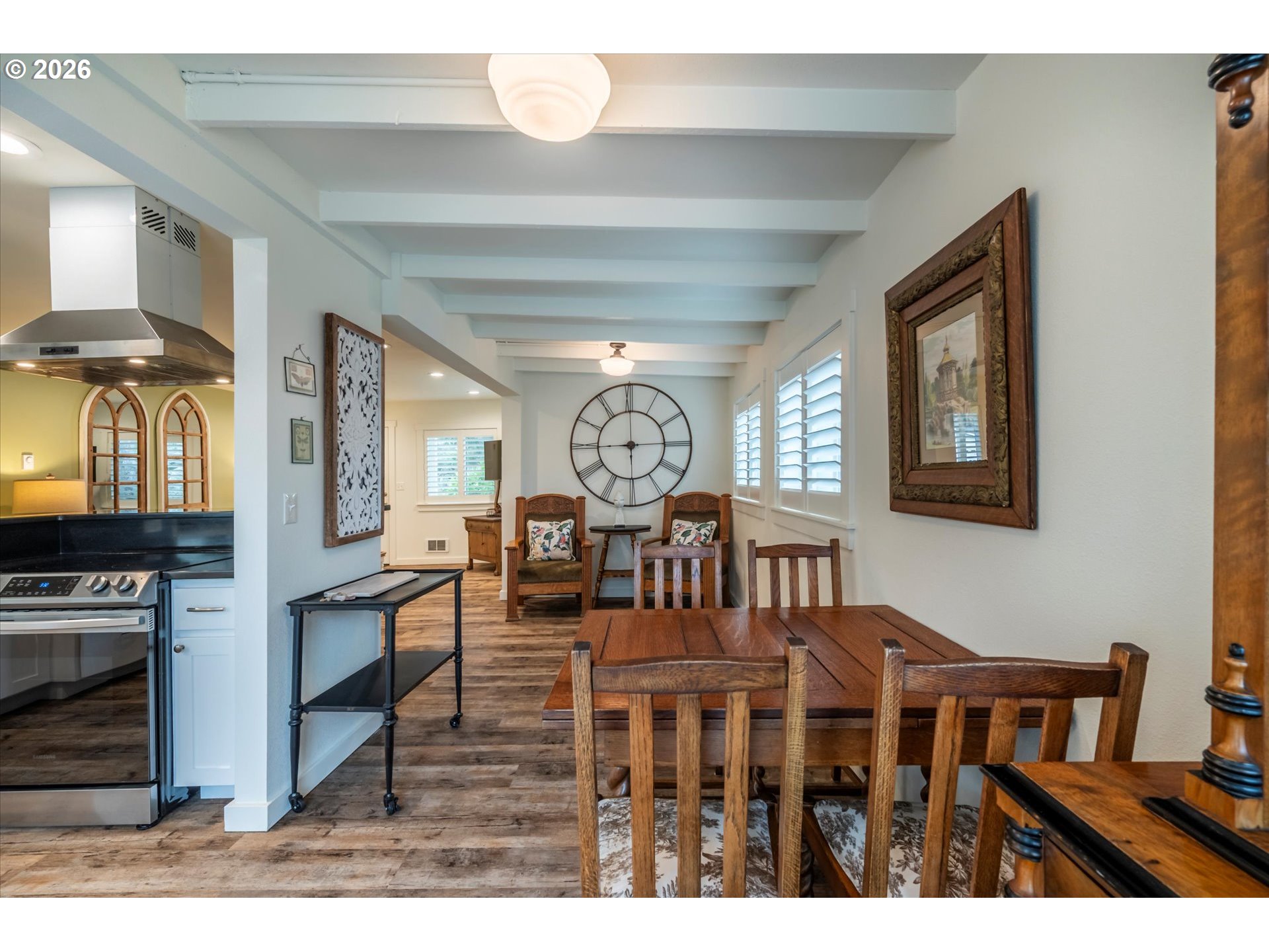 770 9th Street Southeast Bandon, OR 97411 - Photo 12 of 47 a view of a dining room with furniture a chandelier and wooden floor