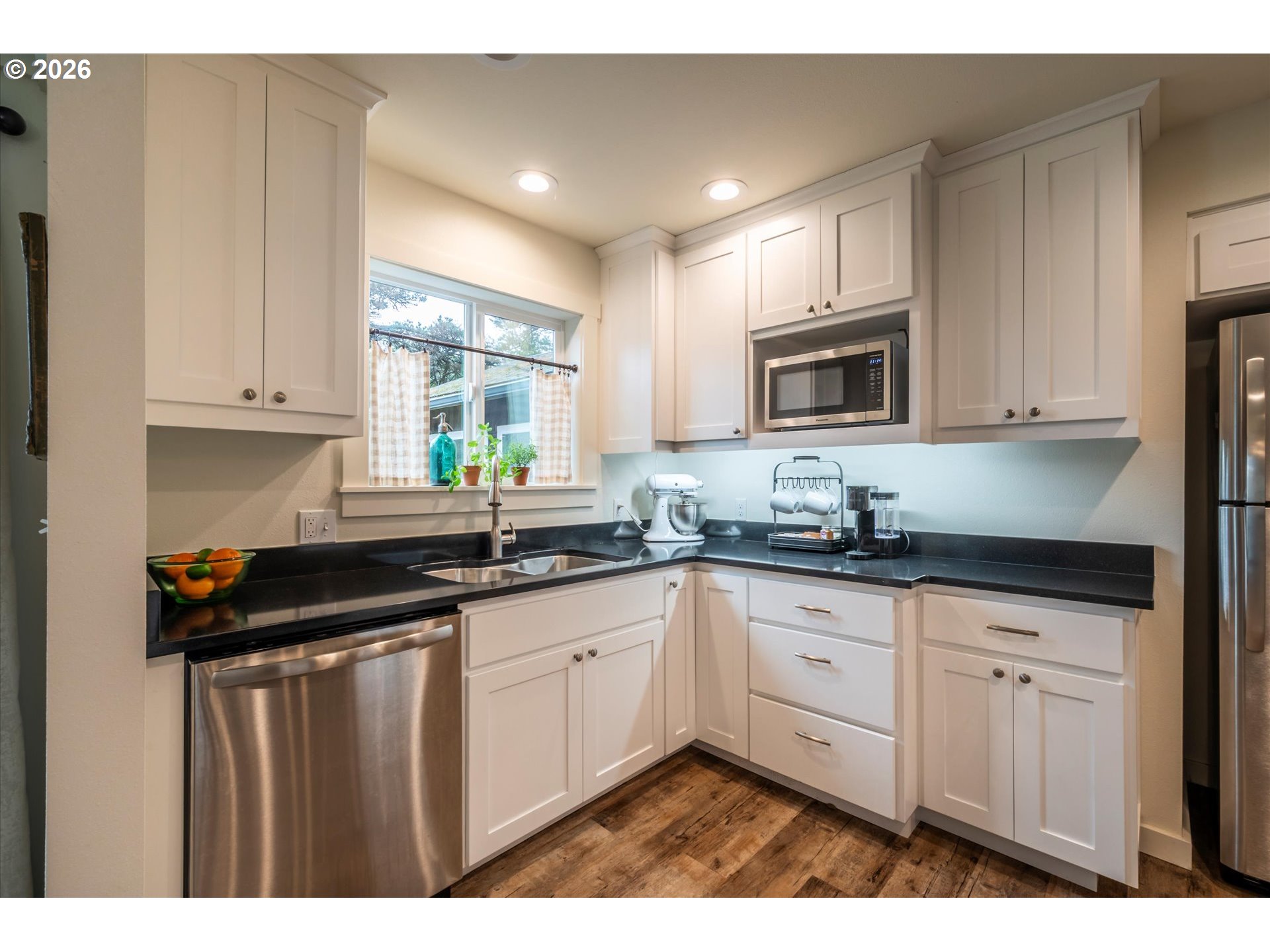 770 9th Street Southeast Bandon, OR 97411 - Photo 14 of 47 a kitchen with sink cabinets and window