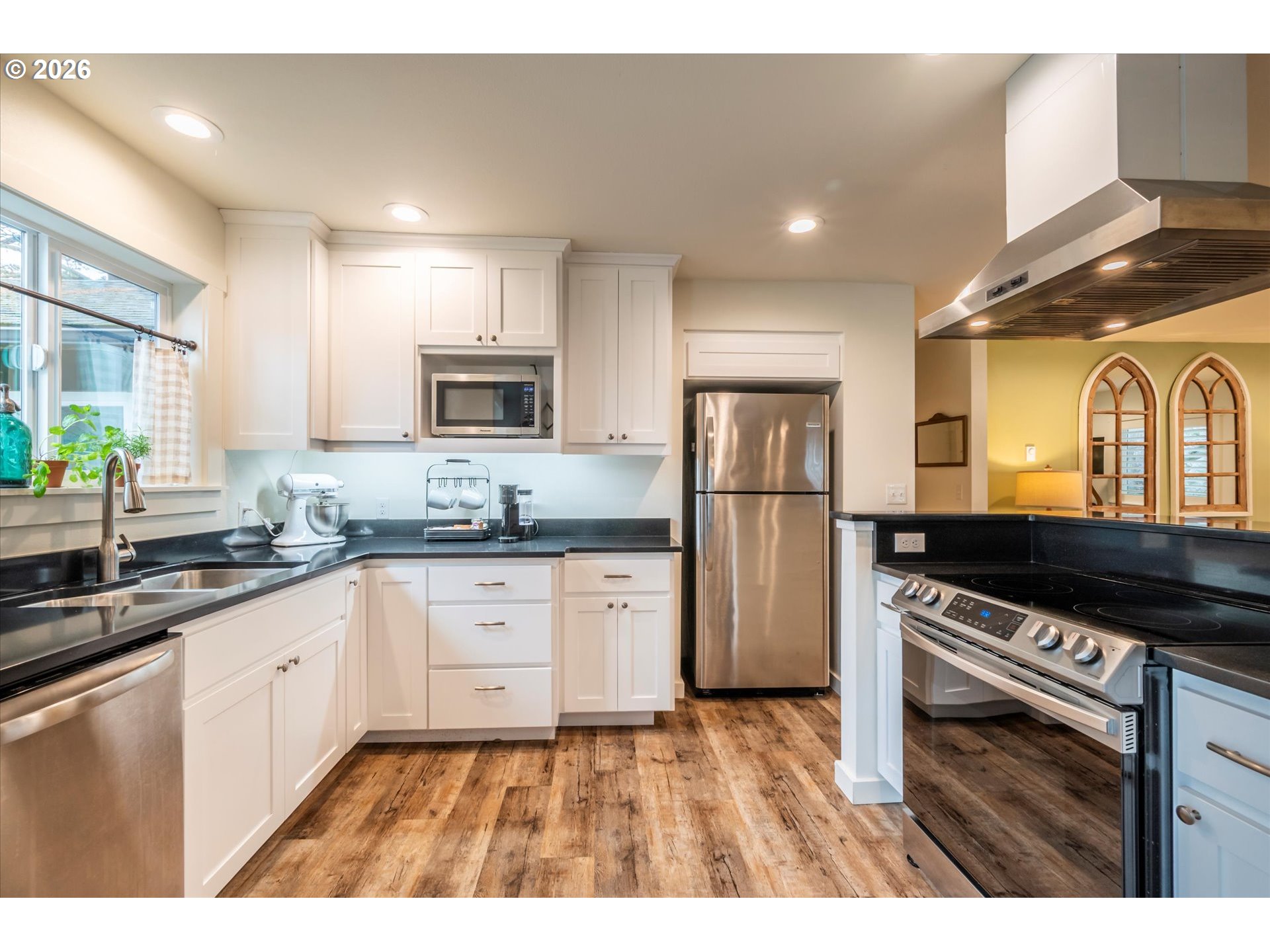 770 9th Street Southeast Bandon, OR 97411 - Photo 15 of 47 a kitchen with stainless steel appliances granite countertop a refrigerator a stove and a sink