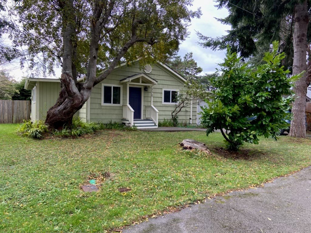 770 9th Street Southeast Bandon, OR 97411 - Photo 2 of 47 a front view of a house with garden