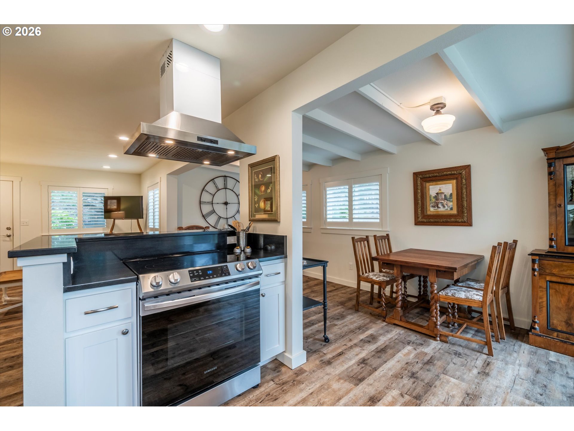 770 9th Street Southeast Bandon, OR 97411 - Photo 21 of 47 a kitchen with stainless steel appliances wooden floor dining table and chairs