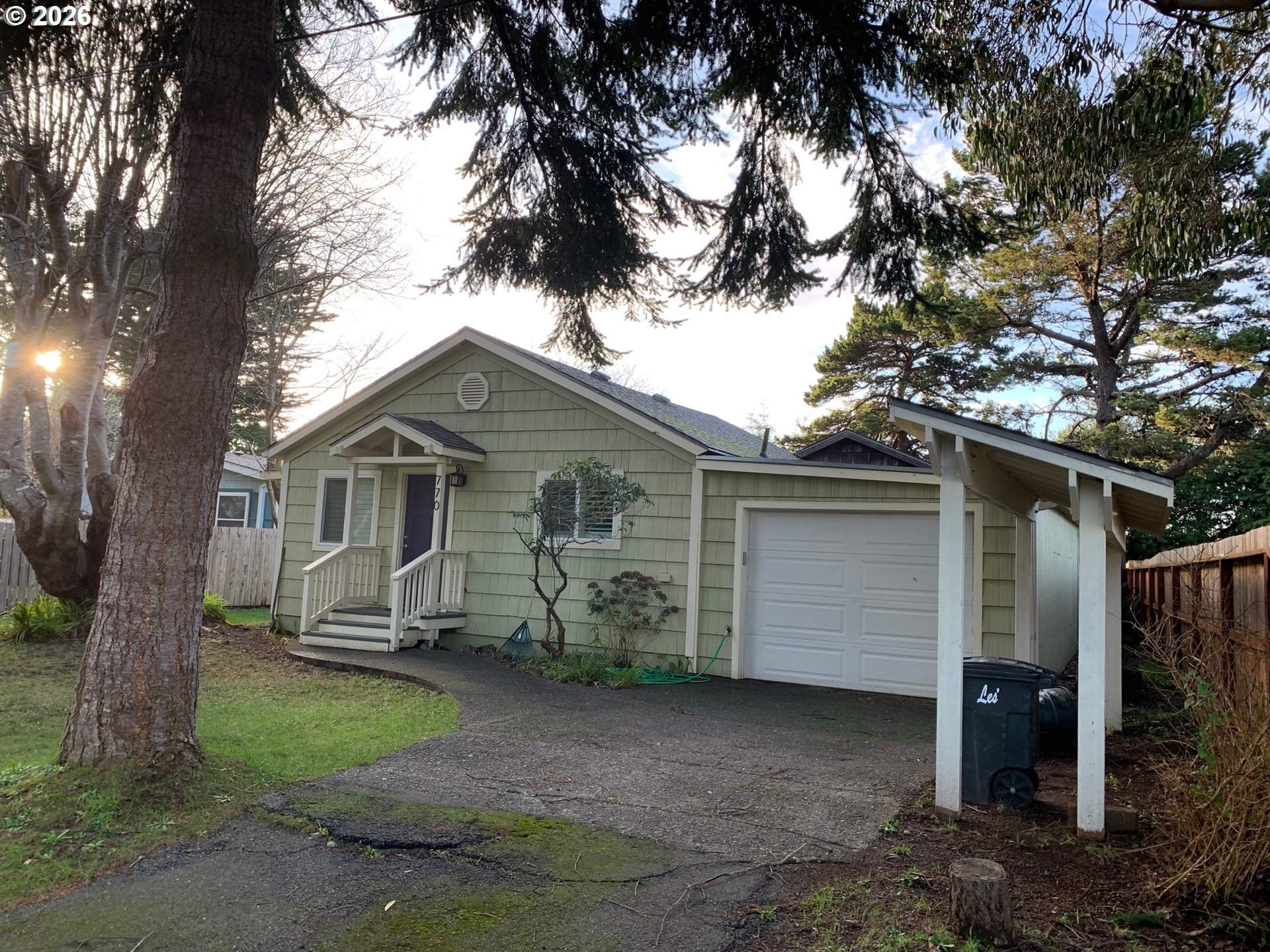 770 9th Street Southeast Bandon, OR 97411 - Photo 3 of 47 a front view of a house with a yard and garage