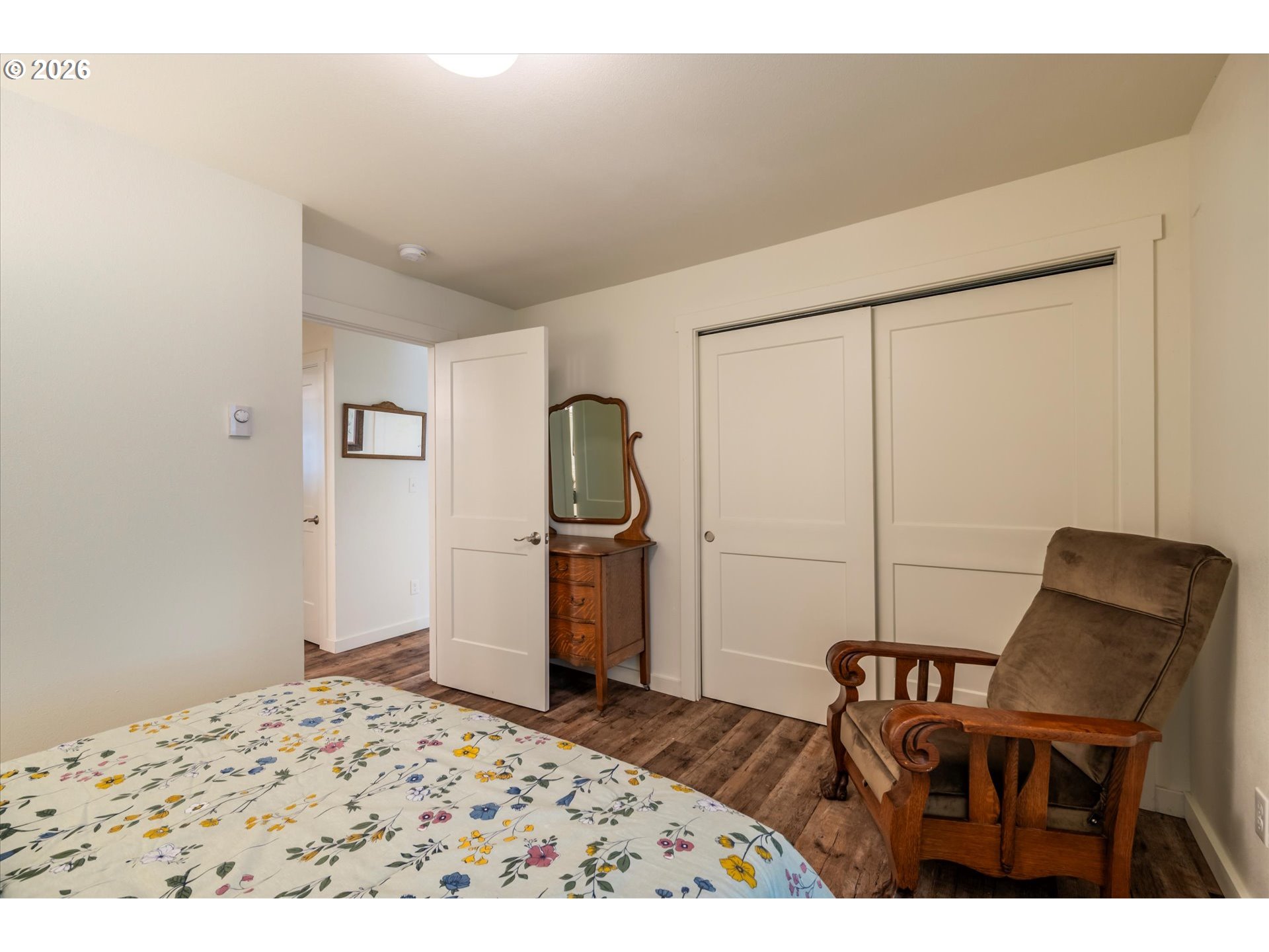 770 9th Street Southeast Bandon, OR 97411 - Photo 34 of 47 a bedroom with a bed and a chair