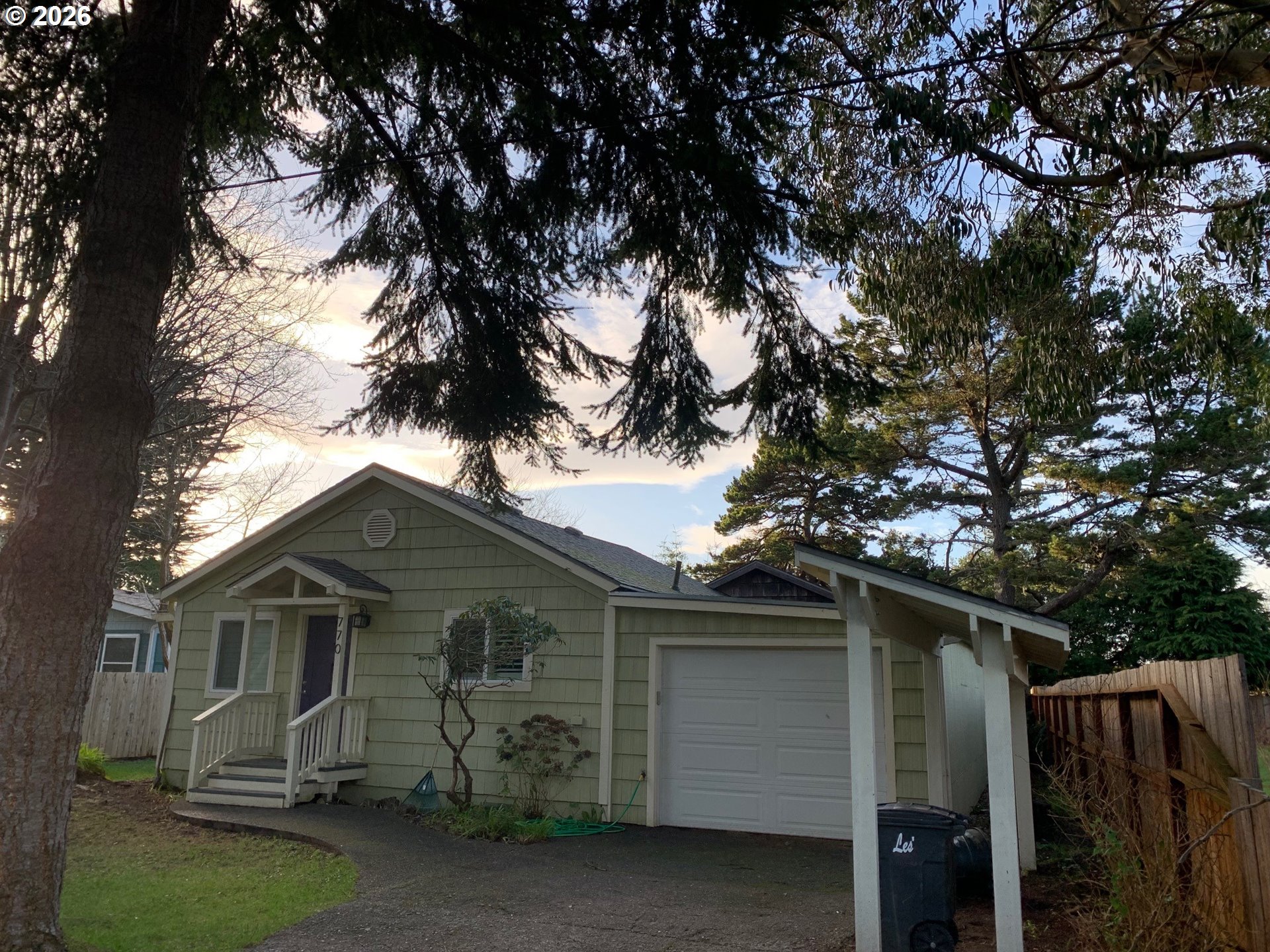 770 9th Street Southeast Bandon, OR 97411 - Photo 4 of 47 a front view of house with yard and trees around