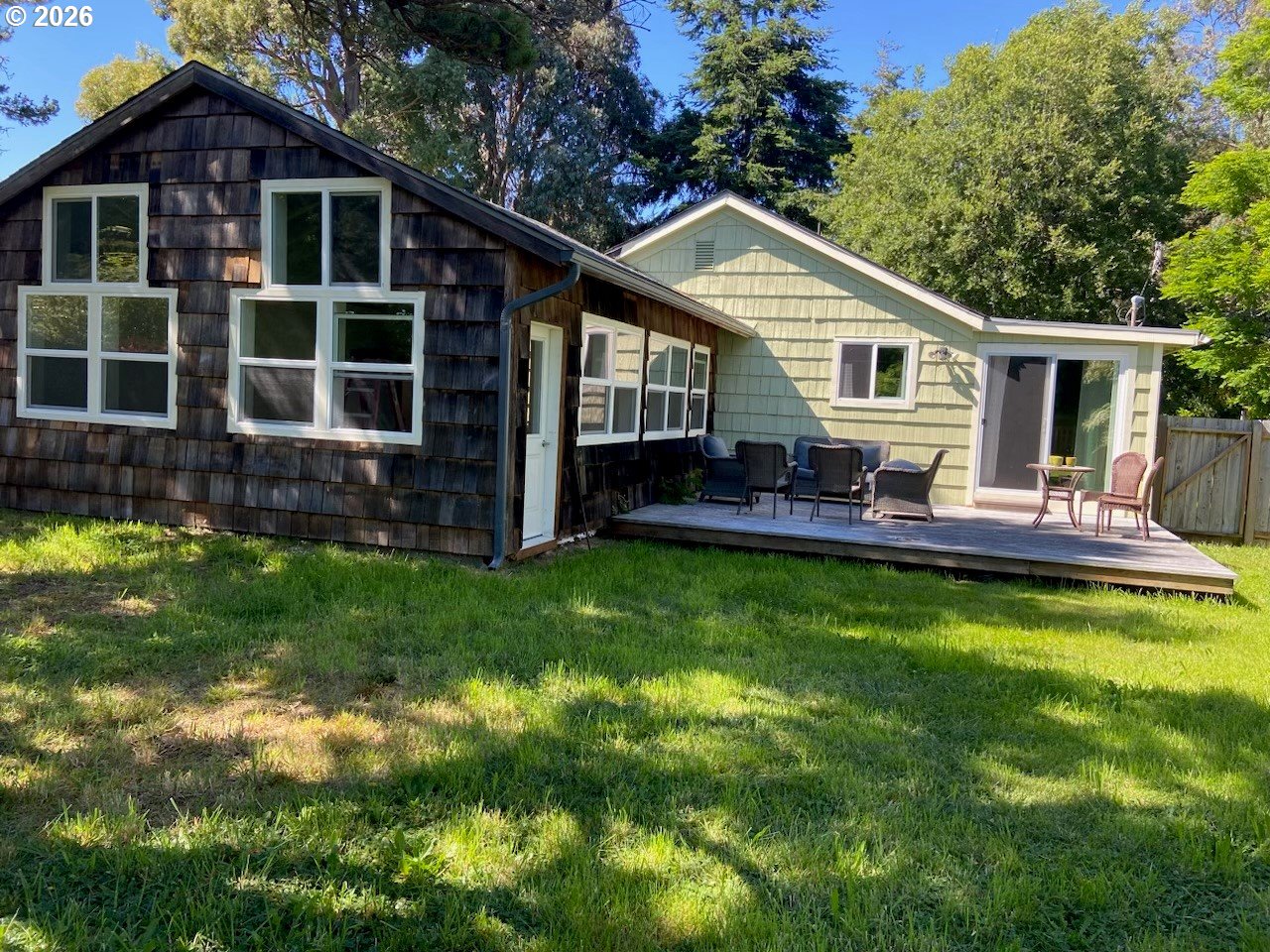 770 9th Street Southeast Bandon, OR 97411 - Photo 6 of 47 a view of a house with a yard and sitting area
