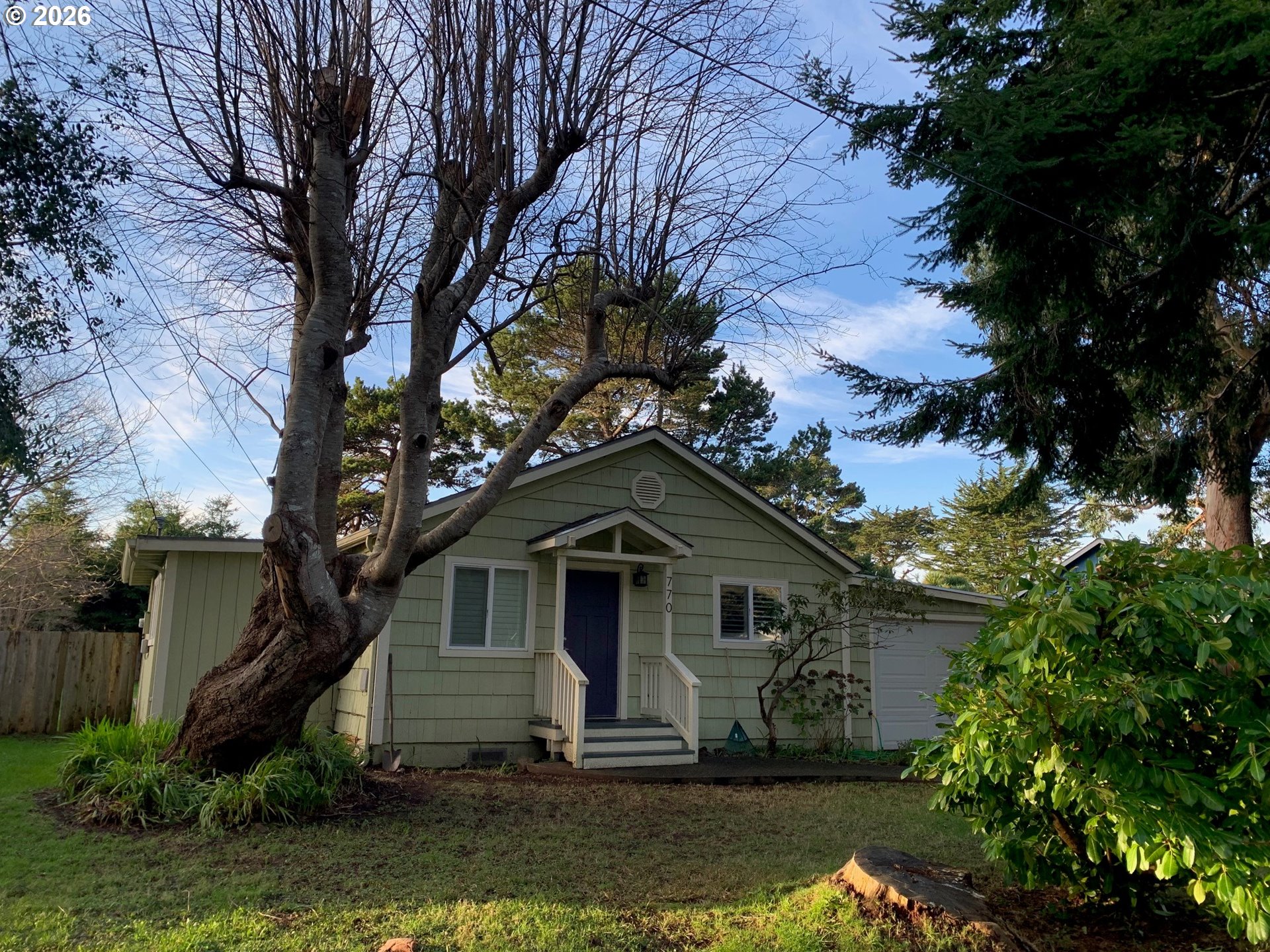 770 9th Street Southeast Bandon, OR 97411 - Photo 8 of 47 a front view of a house with a yard