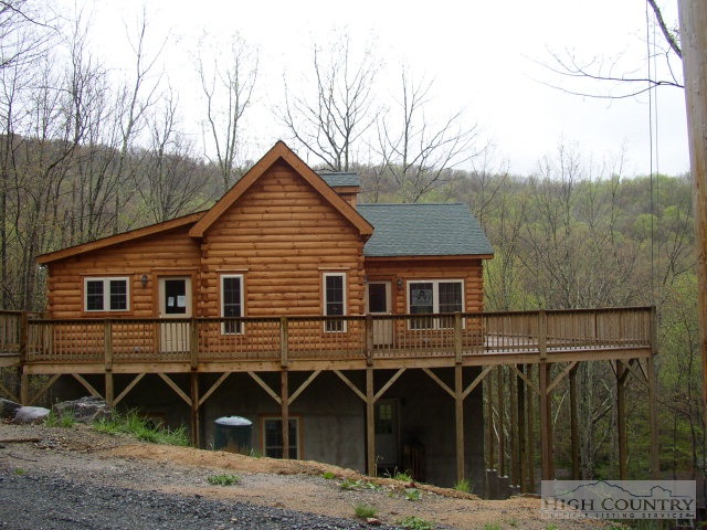 203 Jackpine Road Beech Mountain, NC 28604 - Photo 1 of 1 a front view of a house with yard