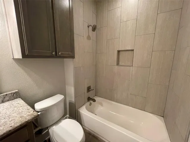 a white bath tub sitting next to a white toilet
