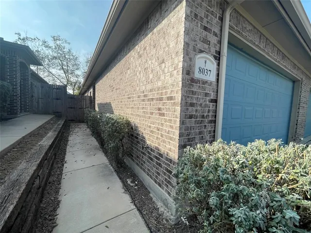 a pathway of a house with backyard