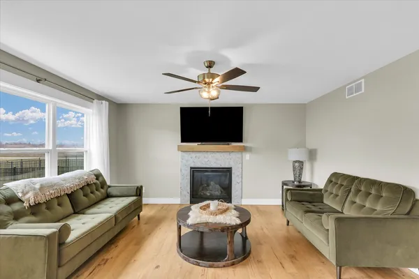 a living room with furniture a fireplace and a flat screen tv