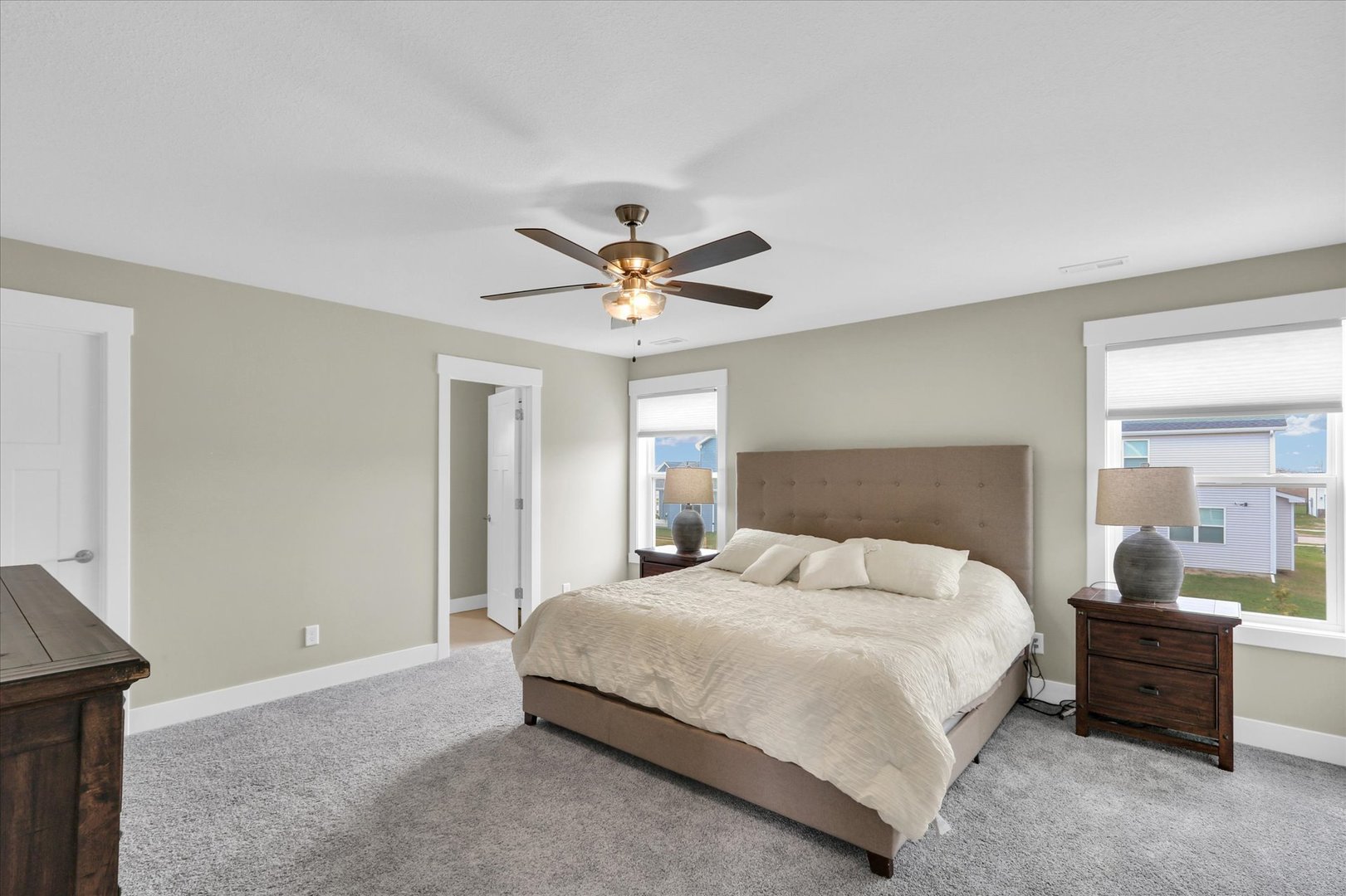 1403 Winterberry Road Savoy, IL 61874 - Photo 17 of 47 a bedroom with a large bed and a ceiling fan