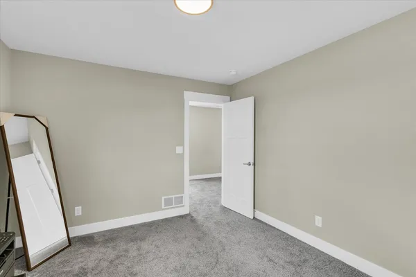 wooden floor with windows and cabinet in a room
