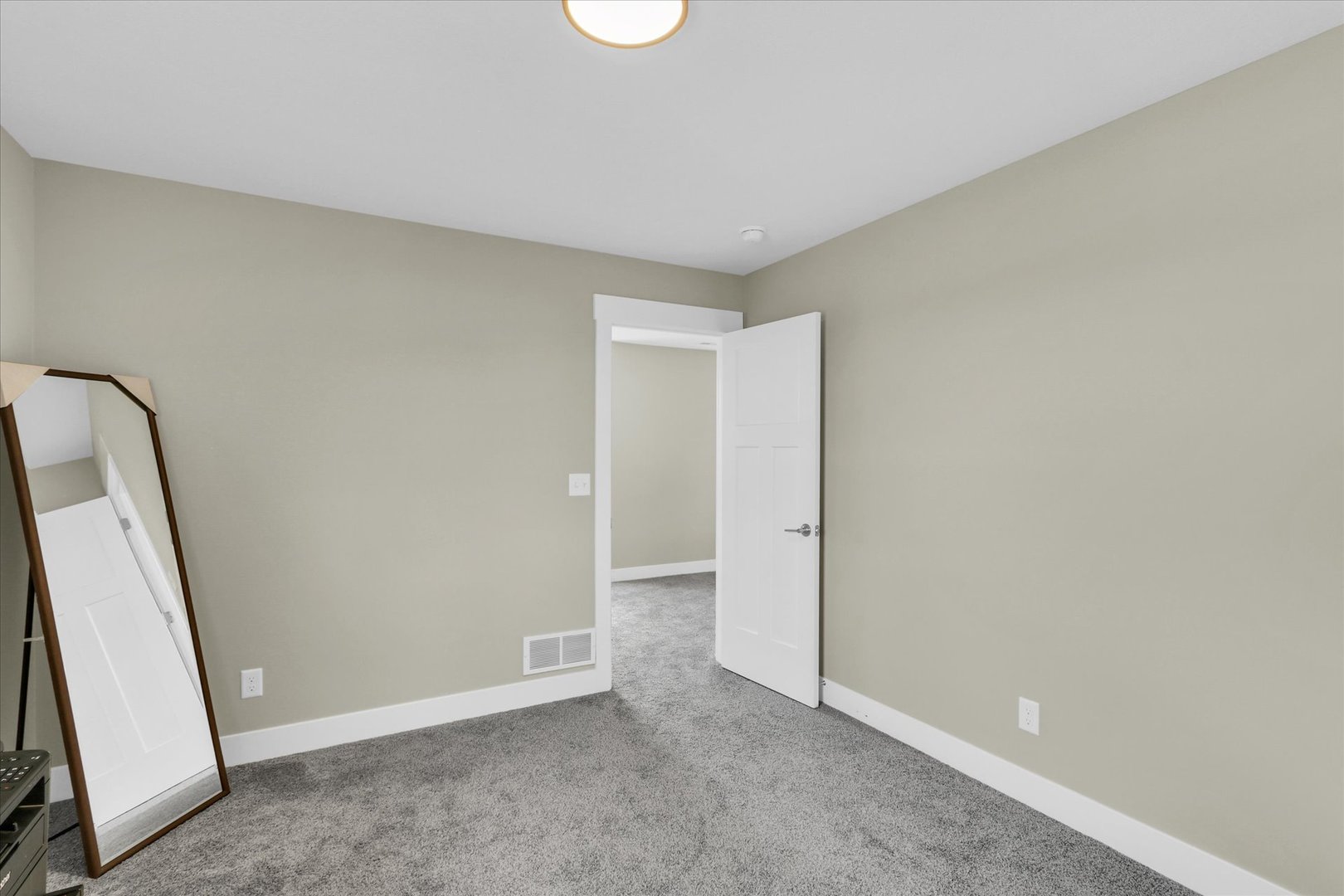 1403 Winterberry Road Savoy, IL 61874 - Photo 22 of 47 an empty room with wooden floor and mirror