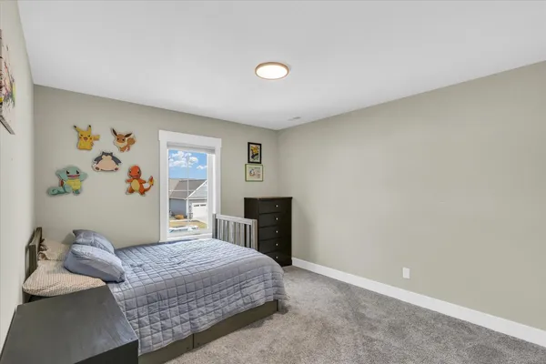 a large bed sitting in a bedroom next to a window