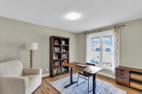 a view of a livingroom with wooden floor and cabinet