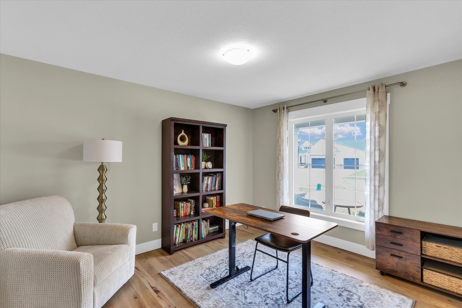 1403 Winterberry Road Savoy, IL 61874 - Photo 3 of 47 a living room with furniture a rug and a bookshelf