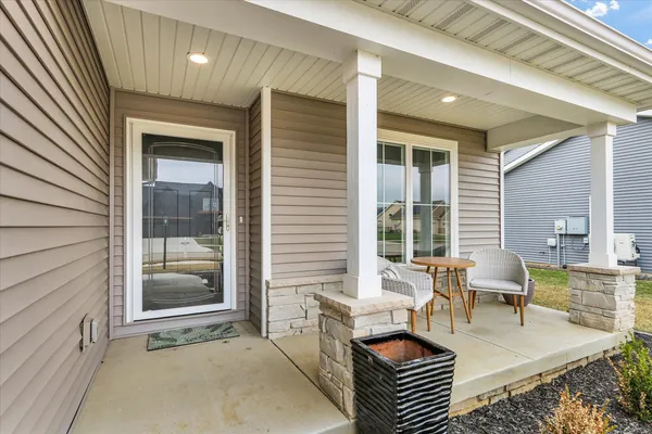 a balcony with furniture and wooden floor