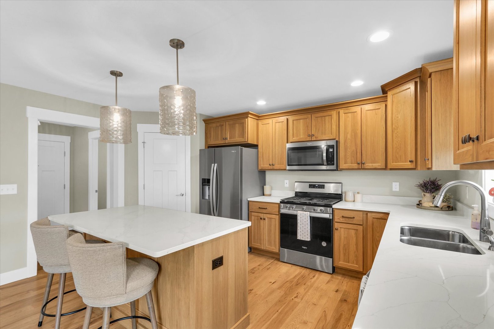 1403 Winterberry Road Savoy, IL 61874 - Photo 6 of 47 a kitchen with a refrigerator a stove top oven a sink dishwasher and cabinets with wooden floor