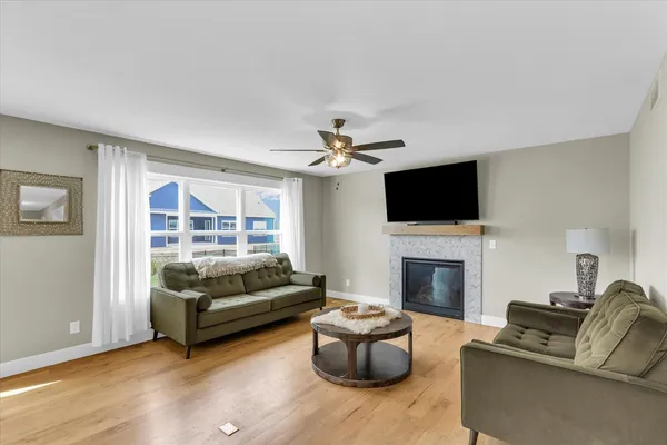 a living room with furniture a fireplace and a flat screen tv