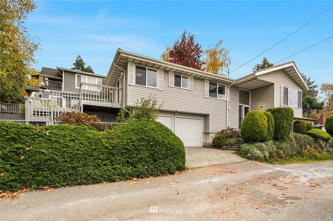 4216 Southwest Myrtle Street Seattle, WA 98136 - Photo 1 of 21 a view of a house with a small yard and potted plants