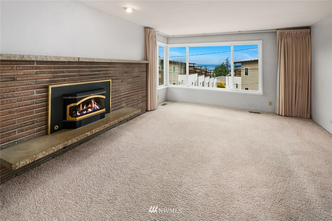 4216 Southwest Myrtle Street Seattle, WA 98136 - Photo 2 of 21 an empty room with windows and fireplace