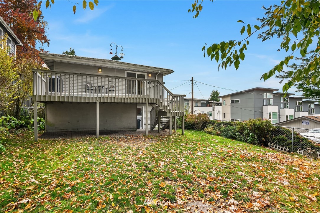 4216 Southwest Myrtle Street Seattle, WA 98136 - Photo 20 of 21 a view of a house with a wooden fence