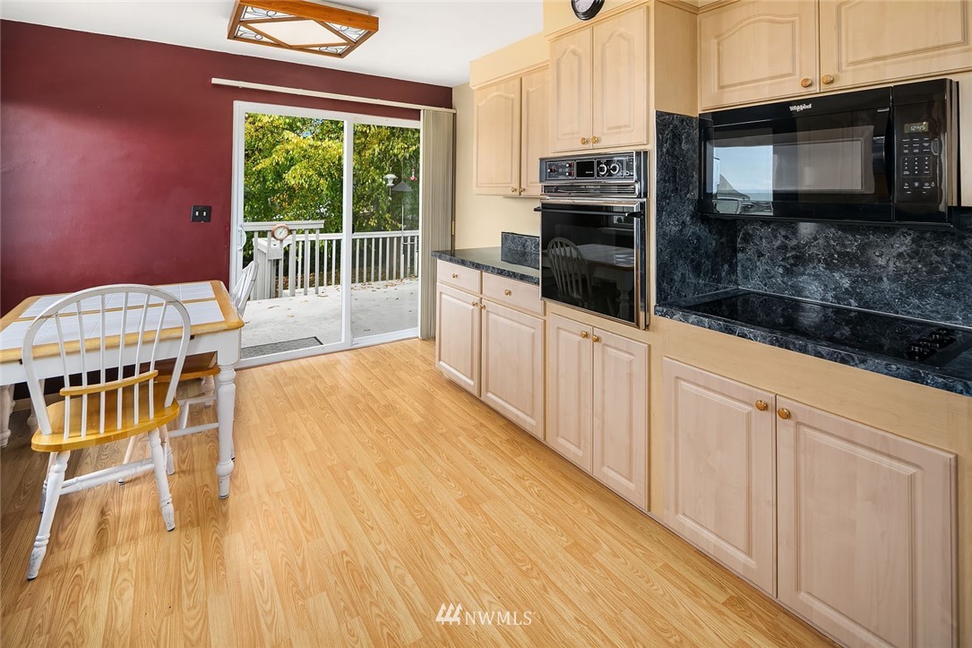 4216 Southwest Myrtle Street Seattle, WA 98136 - Photo 6 of 21 a kitchen with stainless steel appliances granite countertop a stove a sink and a microwave