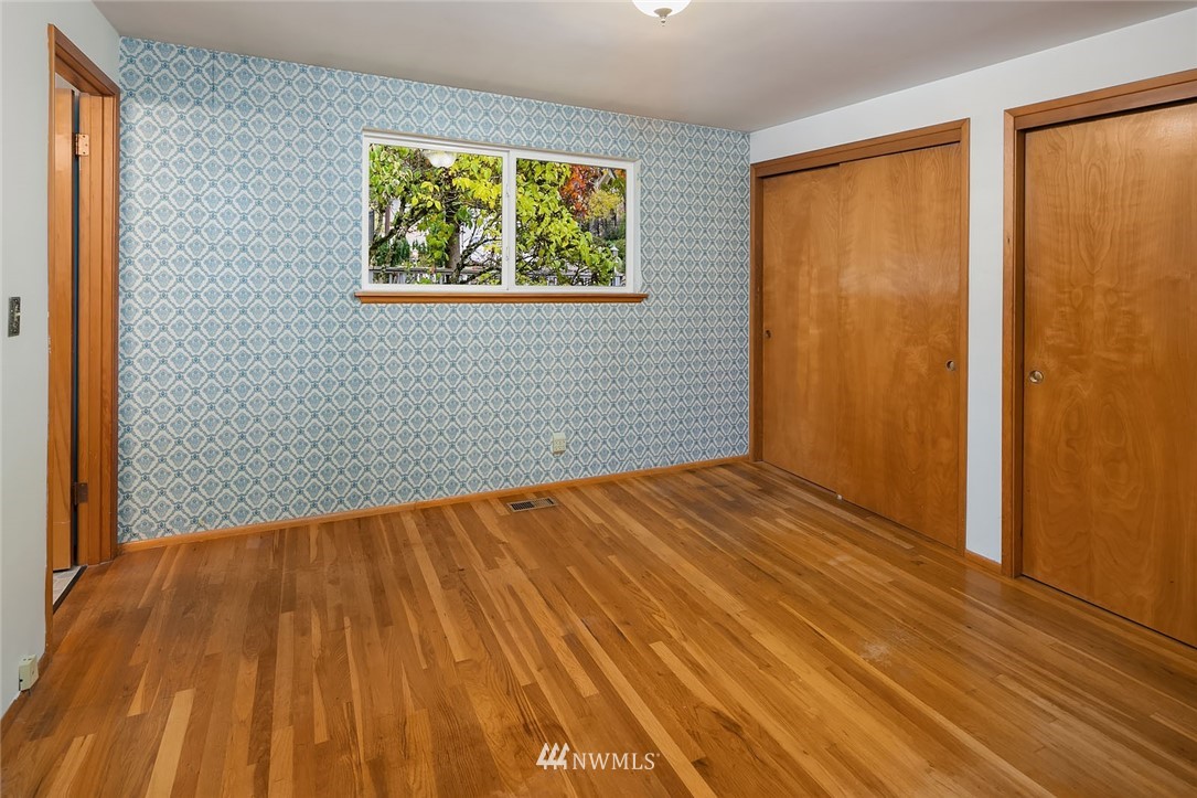 4216 Southwest Myrtle Street Seattle, WA 98136 - Photo 8 of 21 a view of an empty room with wooden floor and a window