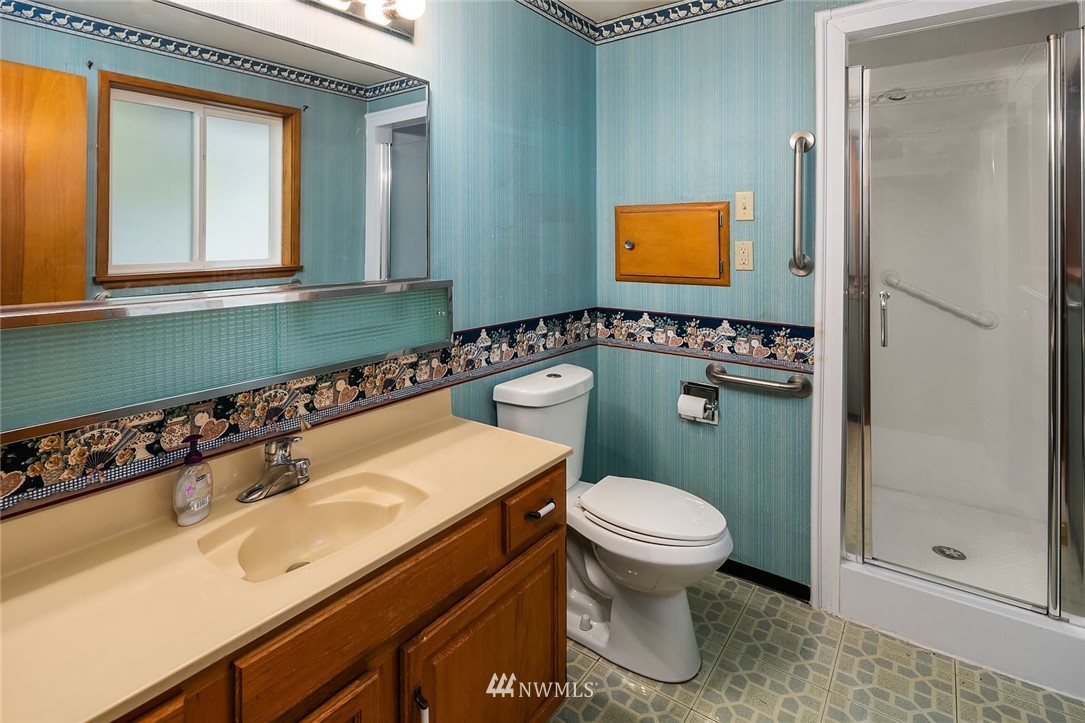 4216 Southwest Myrtle Street Seattle, WA 98136 - Photo 9 of 21 a bathroom with a sink a toilet and mirror