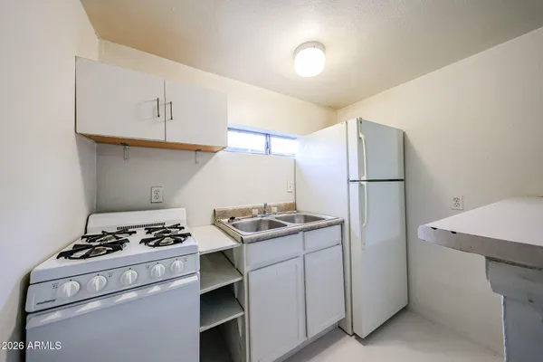 a kitchen with a stove and a refrigerator