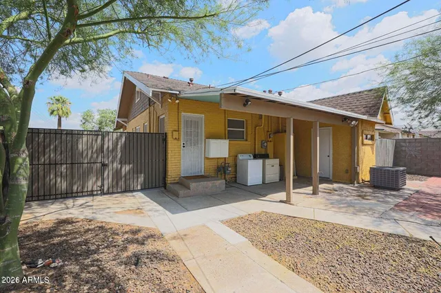 a view of a house with backyard and sitting area