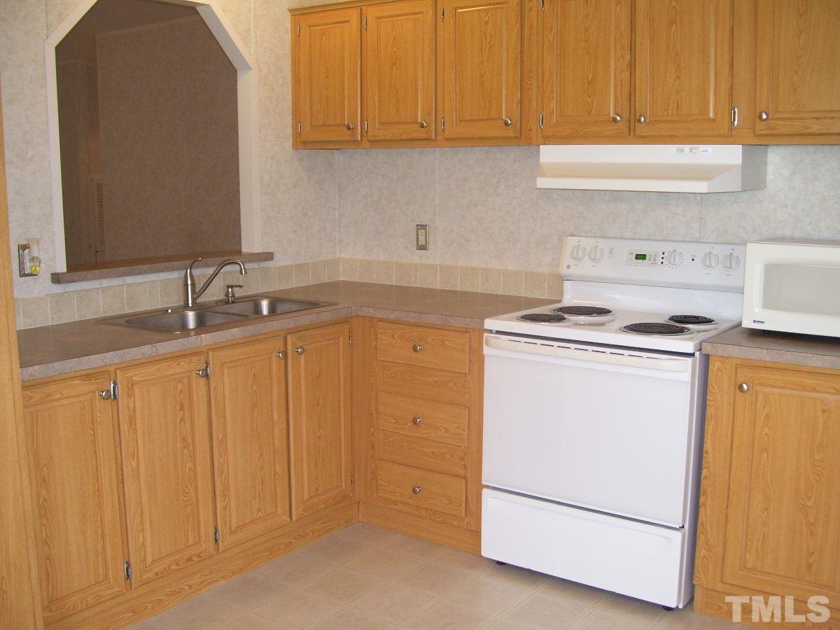249 West O Painter Road Timberlake, NC 27583 - Photo 2 of 20 a kitchen with cabinets appliances and a sink
