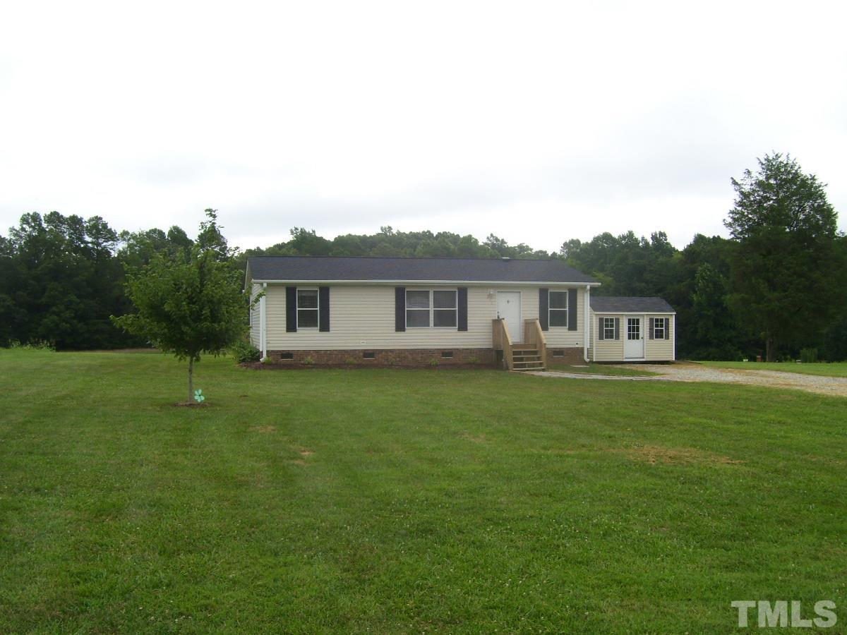 249 West O Painter Road Timberlake, NC 27583 - Photo 16 of 20 a front view of a house with a garden