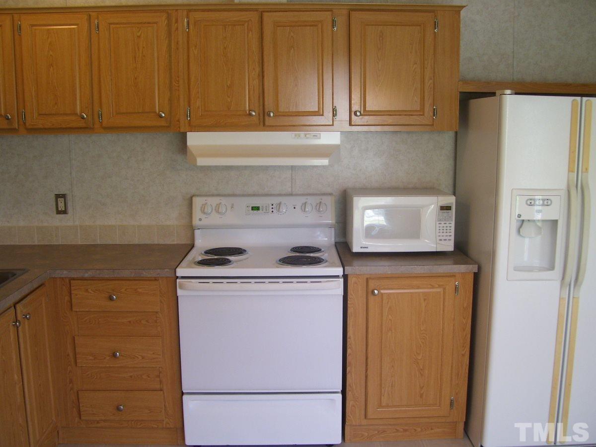 249 West O Painter Road Timberlake, NC 27583 - Photo 3 of 20 a kitchen with a stove and a refrigerator