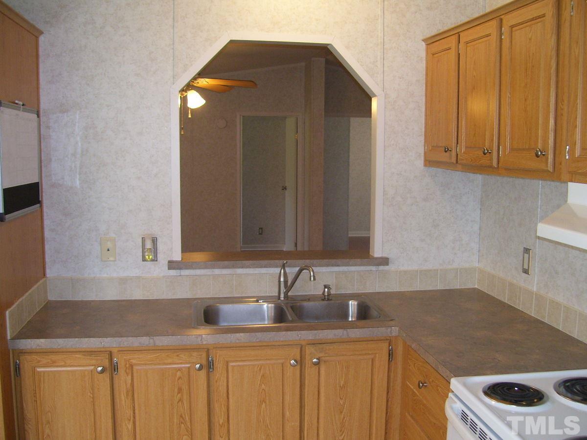 249 West O Painter Road Timberlake, NC 27583 - Photo 4 of 20 a kitchen with a sink and cabinets