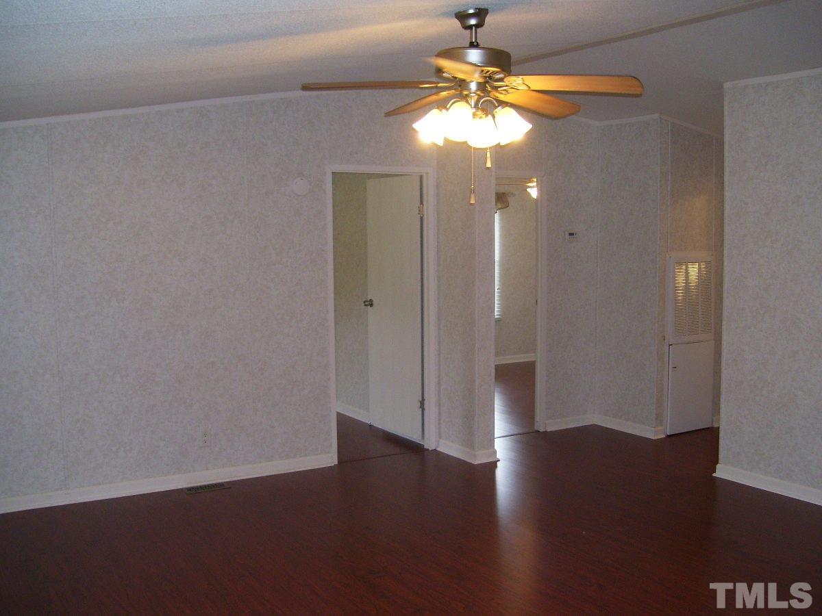 249 West O Painter Road Timberlake, NC 27583 - Photo 5 of 20 an empty room with wooden floor and windows