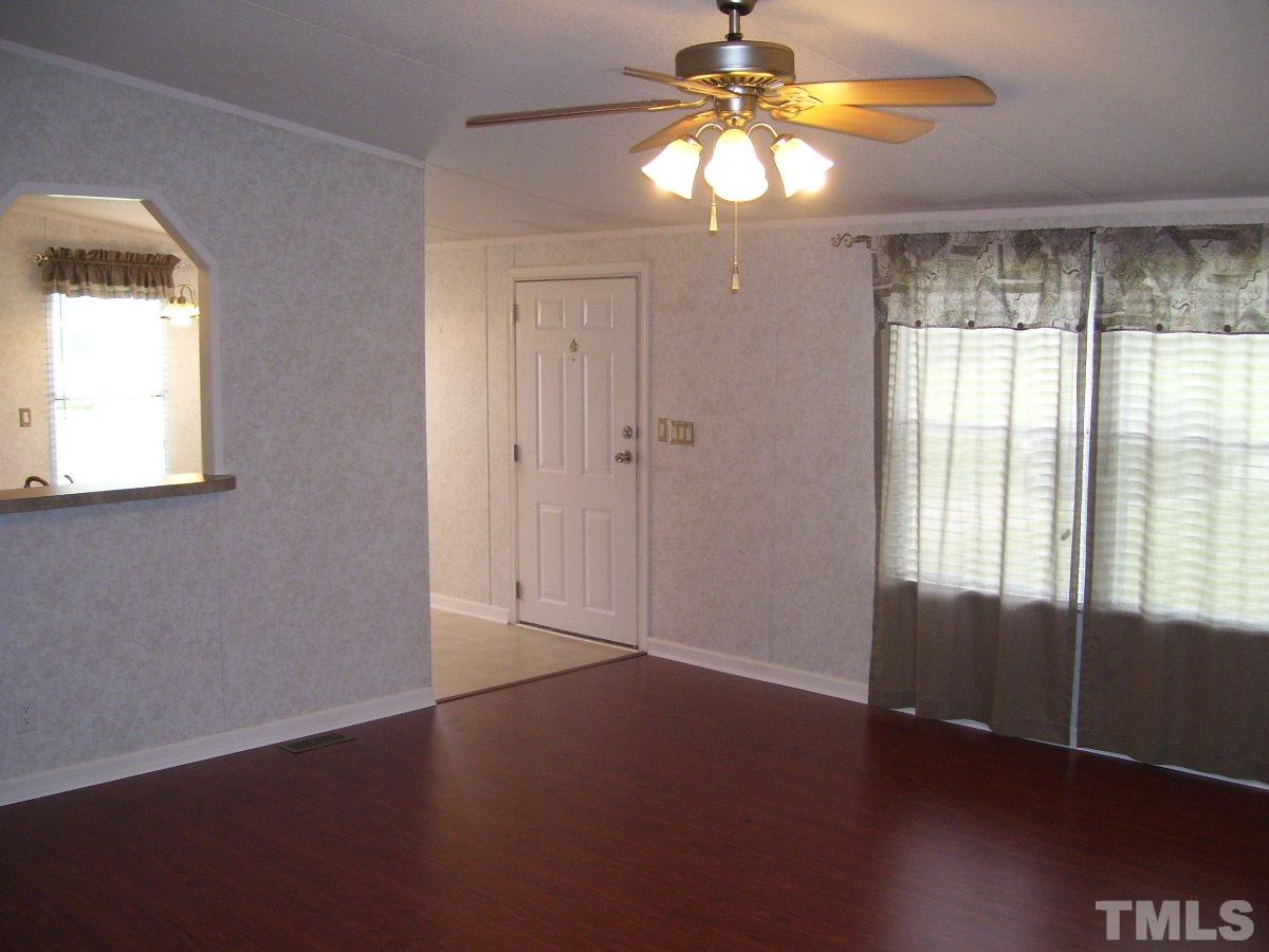 249 West O Painter Road Timberlake, NC 27583 - Photo 7 of 20 an empty room with windows and chandelier fan