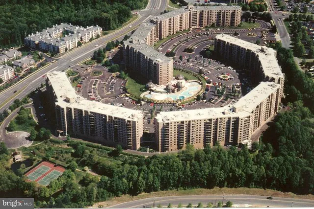 a view of a house with brick walls and flower plants