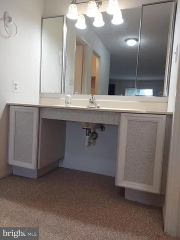 a living room with furniture and a book shelf