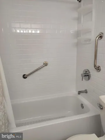 a view of a water pond with green yard