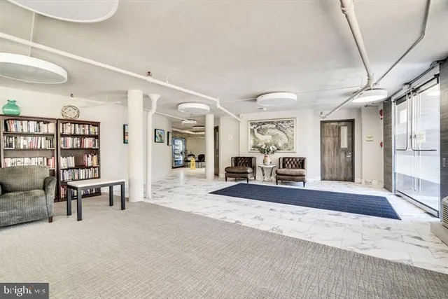 a view of a swimming pool with a patio and fire pit