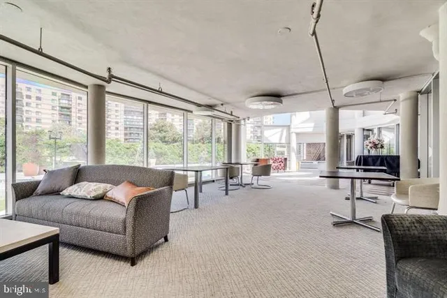 a view of a patio with swimming pool and furniture