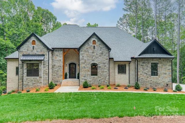a front view of a house with a garden