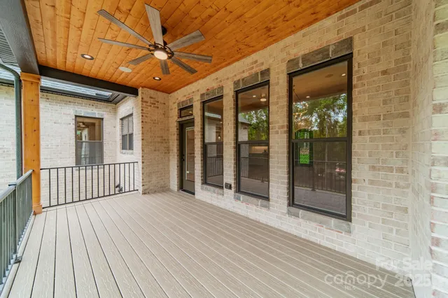 a view of a patio with table and chairs under an umbrella