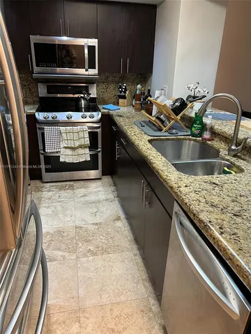 a kitchen with sink a microwave and stove