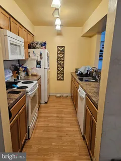 a kitchen with stainless steel appliances granite countertop a stove and a refrigerator